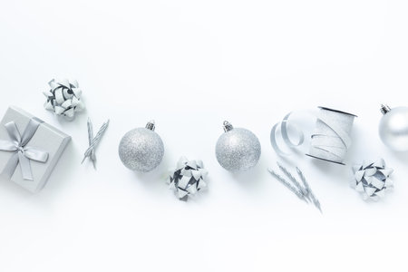 Silver colored Christmas and New Year decorations on white background, top view.の写真素材