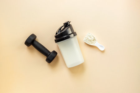 Protein shaker for sports nutrition. Whey protein powder in a scoop, top view.の写真素材