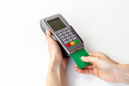 Female holding in hands bank terminal for contactless payment by credit cards. Banking and shopping conceptの写真素材