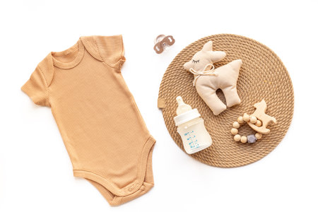 Flat lay with baby bodysuit and eco friendly toys on white background, top view.の写真素材