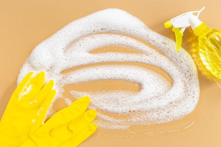 Soap foam background with cleaning supplies and products.