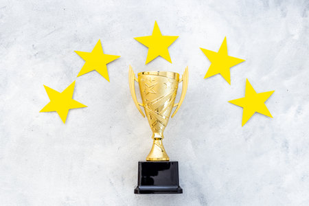 Award golden trophy cup as a symbol of victory. Winning the competition concept.の写真素材