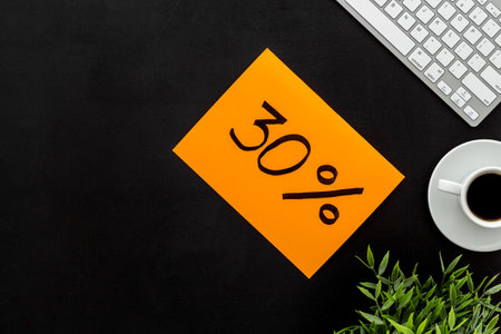 Sales and online shopping concept. Top view of a table with computer and discount percentage sing.の写真素材