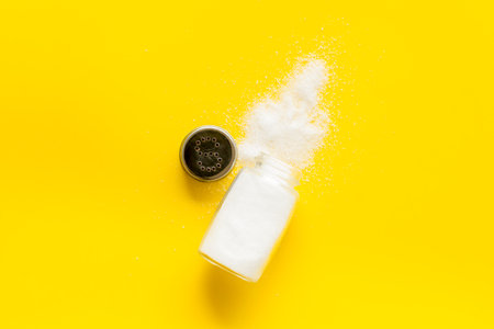 Fine salt in salt shaker and spilled salt. Cooking concept.の写真素材