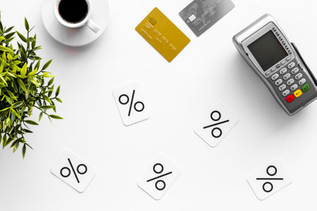 Sales concept with discount sing. Online shopping - table with POS payment terminal and credit cards, top view.の写真素材