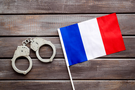 Metal handcuffs for criminals with France flag. Local criminal law and justice concept.の写真素材