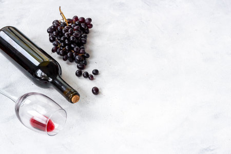 Bottle of wine with wineglass and grapes. Wine background.の写真素材