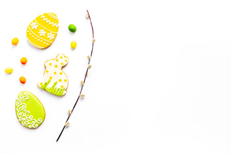 Easter homemade bunny cookies and eggs with willow branches, top view.