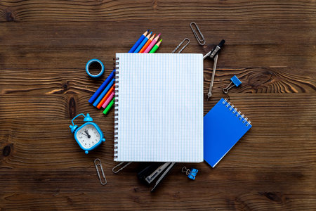 Education concept. Blank sheet of notebook with supplies, top view.