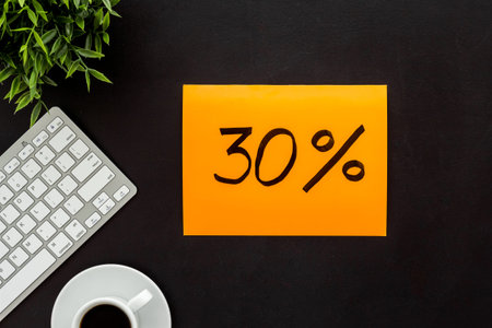 Sales concept. Online shopping - table with computer and discount sing, top view.