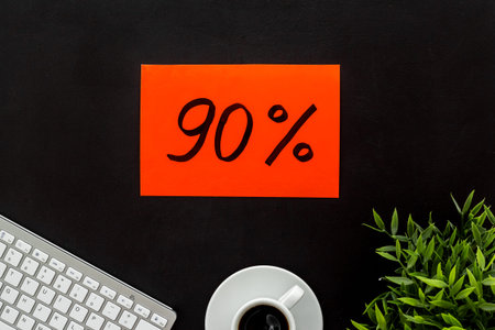 Sales and online shopping concept. Top view of a table with computer and discount percentage sing.