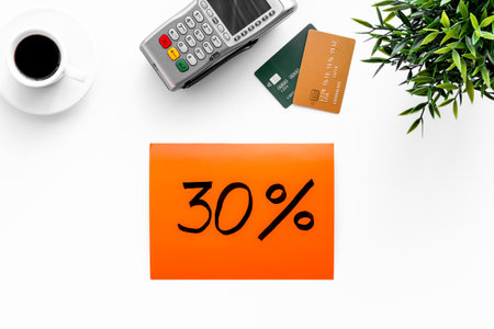 Sales concept with discount sing. Online shopping - table with POS payment terminal and credit cards, top view.の写真素材