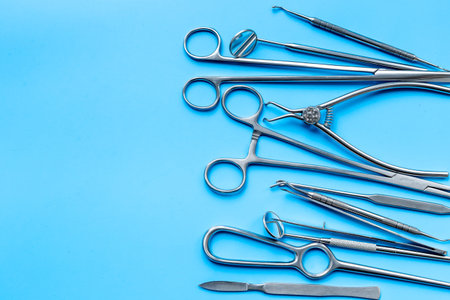 Flat lay of surgical stainless metal hand tools. Professional medical equipment and instruments.