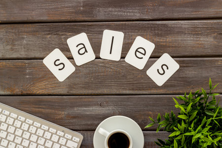 Sales sign on a table with computer, top view. Online shopping concept.の写真素材