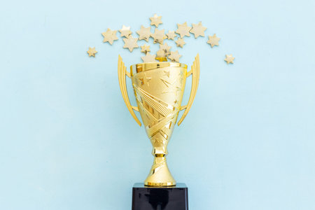 Award golden trophy cup as a symbol of victory. Winning the competition concept.の写真素材