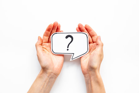 Hands are holding Question mark speech bubbles top view. FAQ concept.の写真素材