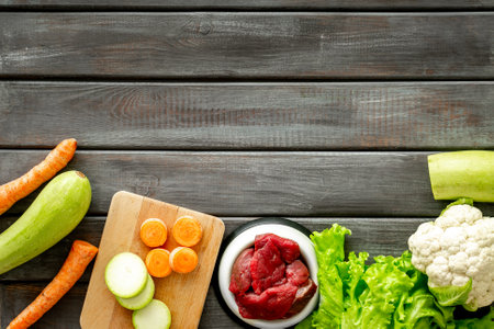 Cooking natural pet food with meat and vegetables, top view.の写真素材