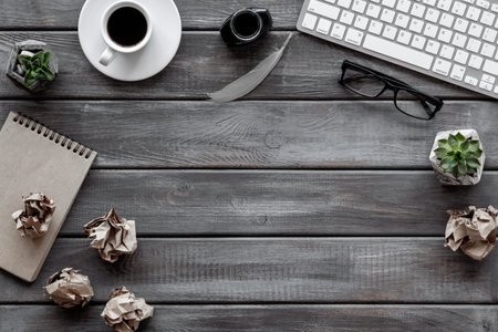 Lumps paper drafts with books and inkwell. Concept of creativity and inspiration. Writer or blogger working space desktop.の写真素材