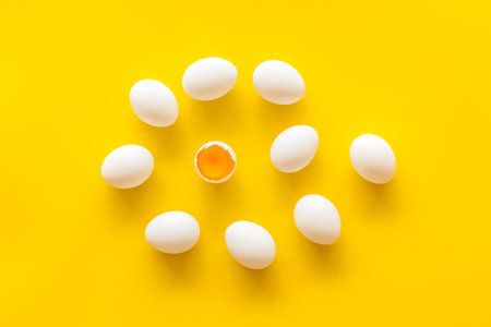 Set of chicken eggs on yellow background, top view. Food pattern.の写真素材