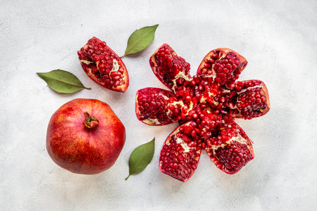 Top view of fresh ripe pomegranate with half and pieces ready for eatingの写真素材