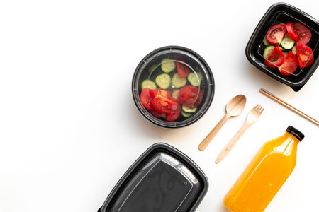 Tomatoes salad in plastic delivery tray, top view. Catering concept.