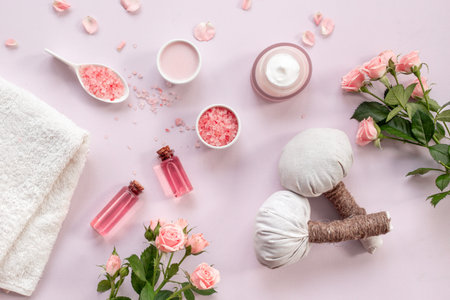 Homemade organic cosmetic with roses essential oil. Face cream with flowers and petals, top view.の写真素材