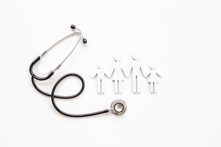 Family wooden figure with medical stethoscope - health care and insurance concept. top view.の写真素材