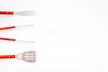 Set with barbecue utensils and equipment with red napkin. Stainless steel tools. Top view.の写真素材