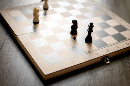 White chess knight pieces and other pieces on chessboard during the game.