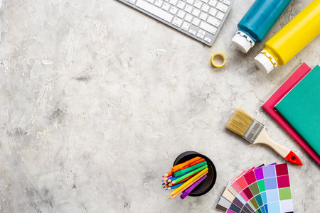Creative designer workspace with color paint swatches and brushes.の写真素材
