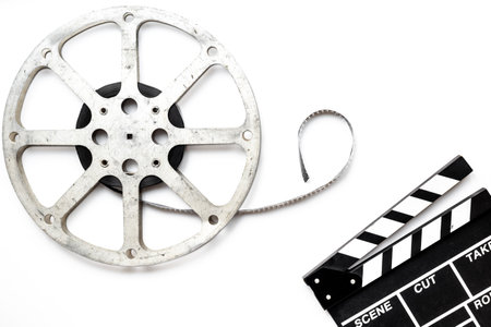 Old movie film reel directors clapperboard on white background.の写真素材
