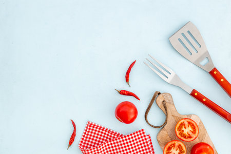 Picnic or party flatlay with barbecue utensils and vegetables, top view.の写真素材