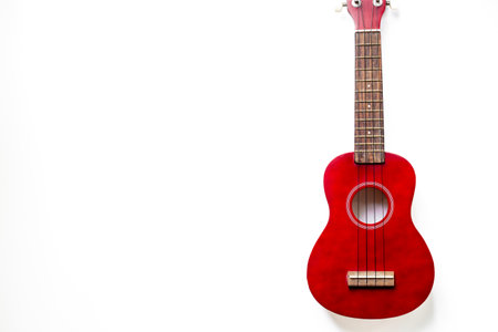 Brown four string ukulele guitar, musical instrument, cut out isolated on whiteの写真素材
