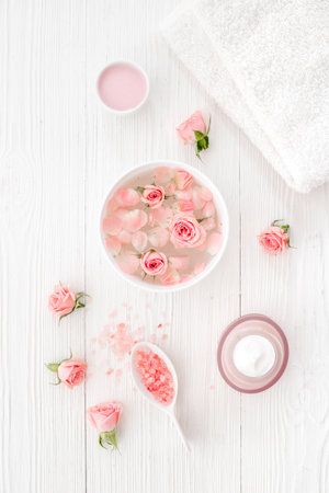 Spa and beauty routine concept with pink roses and essence water with petalsの写真素材