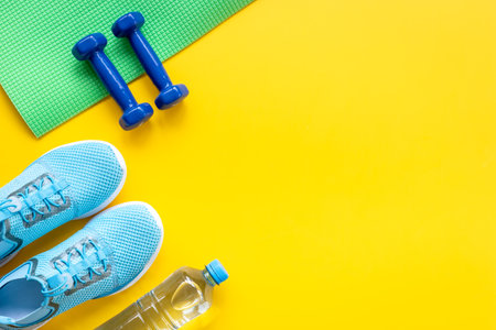 Sport fitness tolls flat lay with sneakers and dumbbells, top viewの写真素材