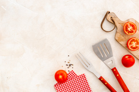 Stainless steel utensils and red picnic napkin, top view. Barbecue utensilsの写真素材