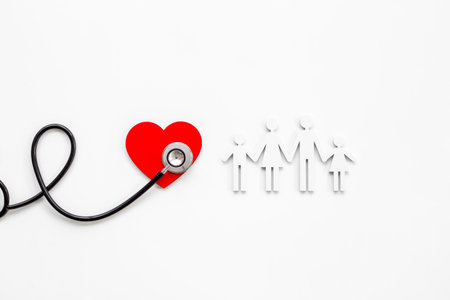Family wooden figure with medical stethoscope - health care and insurance concept. top view.の写真素材