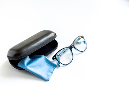 Stylish eyeglasses with glasses case on white. Eye care and protection concept.の写真素材
