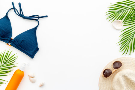 Bikini swimsuit with sunglasses and sunscreen - tropical flat lay.の写真素材