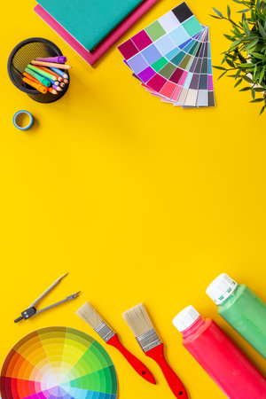 Creative designer workspace with color paint swatches and brushes.の写真素材