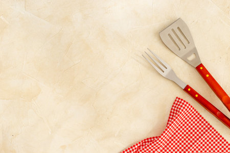 Set with barbecue utensils and equipment with red napkin. Stainless steel tools. Top view.の写真素材