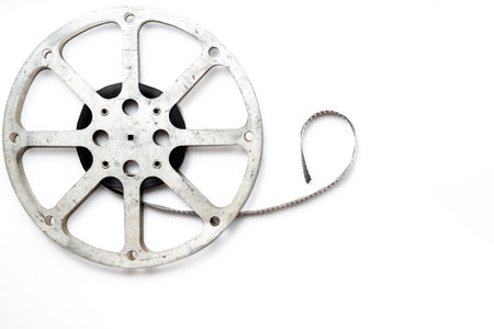 Old 35mm motion picture film reel on white background. Cinema concept.の写真素材