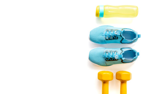 Top view of gym sports equipment with sneakers and dumbbells. Wellness concept.の写真素材