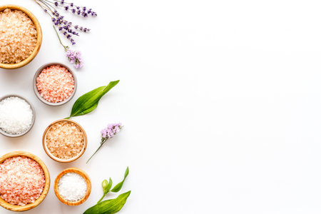 Beauty spa therapy cosmetics and wellness flat lay - sea salt in many bowls with flowers, top view.の写真素材