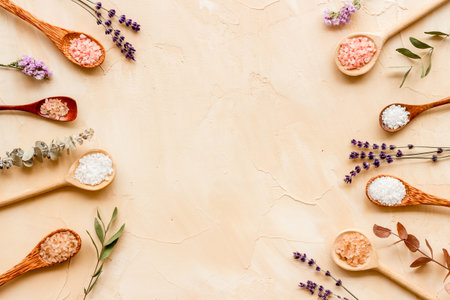 Beauty spa therapy cosmetics and wellness flat lay - sea salt in many spoons with flowers, top view.の写真素材