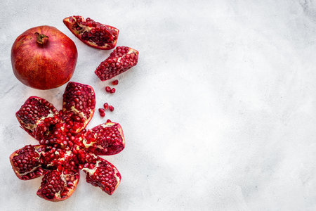 Top view of fresh ripe pomegranate with half and pieces ready for eating.の写真素材