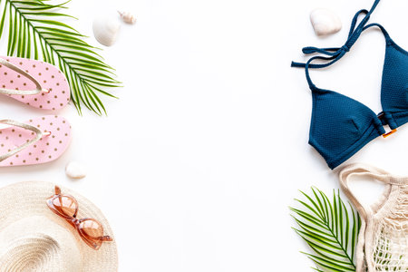 Tropical beach flat lay with swimwear and beach accessories, top view.の写真素材