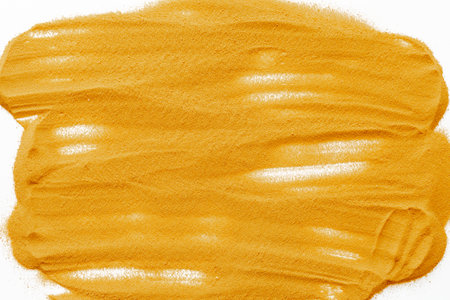 Yellow sand texture background, close up top view. Abstract sand surface.
