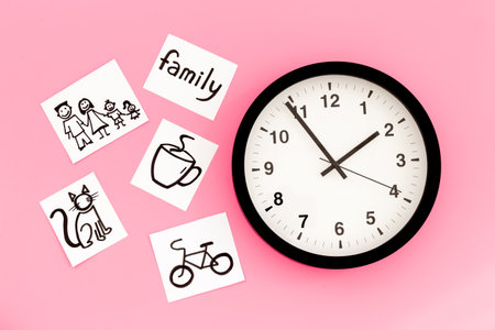 Wall clock and many paper cards with hand drawing of different life activities, top view. Time management concept. Life balance and planning concept.の写真素材