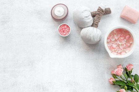 Facial roses essence water and face cream with pink flowers and petals, top view. Beauty routine concept.の写真素材